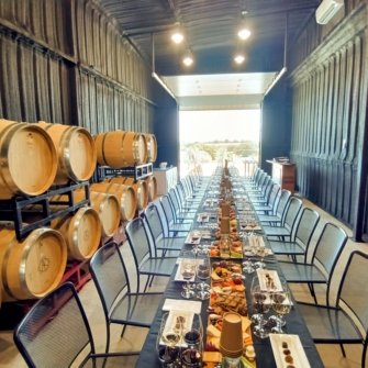 wine and food on tables in barrel room