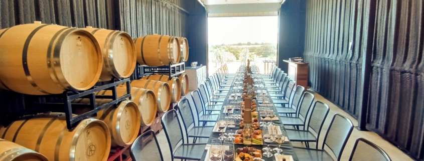 wine and food on tables in barrel room